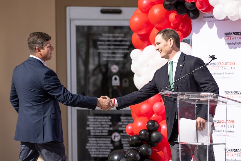 Dallas County Judge Clay Lewis Jenkins (right) and Garland Mayor Dylan Hedrick shook hands...