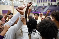 Denton High head coach Michael Thomas (left) and his team celebrate their win over Birdville...