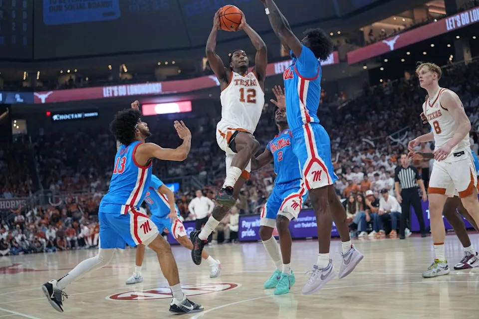 AUSTIN, TEXAS – FEBRUARY 7: Tramon Mark #12 of the Texas Longhorns drives to the basket against Corey Chest #1 and Kezza Giffa #13 of the Ole Miss Rebels during the first half at Moody Center on February 7, 2026 in Austin, Texas. (Photo by Scott Wachter/Getty Images)