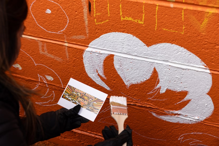 A volunteer fills in cotton on a Sunny South Dallas mural created by artist Theo Ponchaveli...