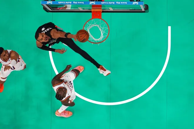 Feb 19, 2026; Austin, Texas, USA; San Antonio Spurs forward Victor Wembanyama (1) dunks over Phoenix Suns forwards Rasheer Fleming (20) and Ryan Dunn (0) during the second half at Moody Center.