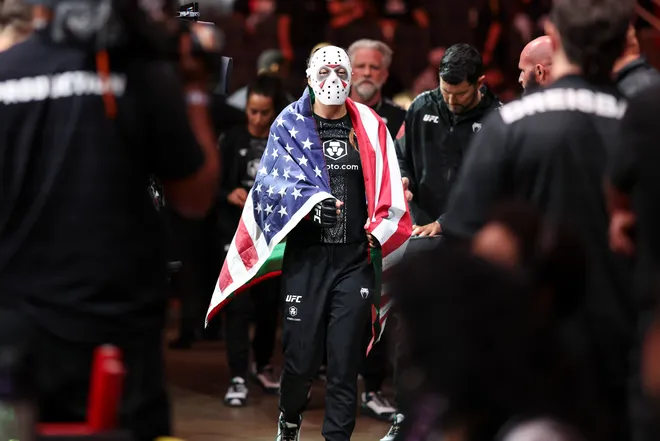 Feb 21, 2026; Houston, Texas, USA; Juliana Miller (red gloves) fights Carli Judice (blue gloves) in a womens flyweight bout during UFC Fight Night at Toyota Center. Mandatory Credit: Troy Taormina-Imagn Images