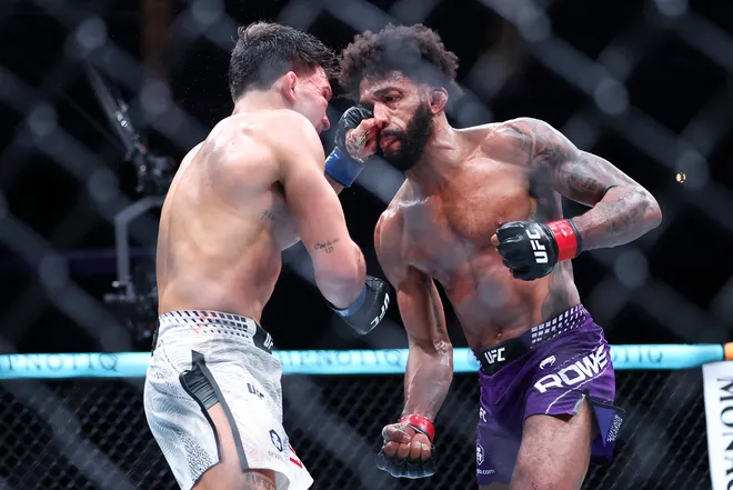 Feb 21, 2026; Houston, Texas, USA; Phil Rowe (red gloves) fights Jean-Paul Lebosnoyani (blue gloves) in a welterweight bout during UFC Fight Night at Toyota Center. Mandatory Credit: Troy Taormina-Imagn Images