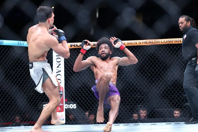 Feb 21, 2026; Houston, Texas, USA; Phil Rowe (red gloves) fights Jean-Paul Lebosnoyani (blue gloves) in a welterweight bout during UFC Fight Night at Toyota Center. Mandatory Credit: Troy Taormina-Imagn Images
