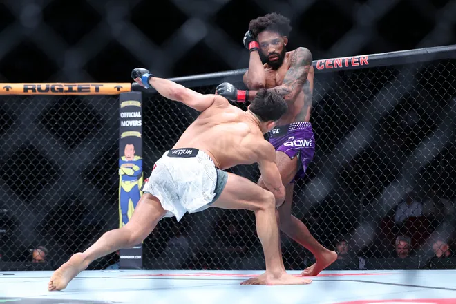 Feb 21, 2026; Houston, Texas, USA; Phil Rowe (red gloves) fights Jean-Paul Lebosnoyani (blue gloves) in a welterweight bout during UFC Fight Night at Toyota Center. Mandatory Credit: Troy Taormina-Imagn Images