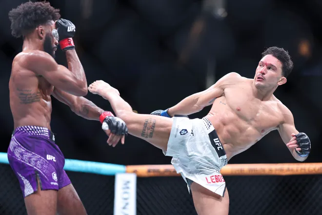 Feb 21, 2026; Houston, Texas, USA; Phil Rowe (red gloves) fights Jean-Paul Lebosnoyani (blue gloves) in a welterweight bout during UFC Fight Night at Toyota Center. Mandatory Credit: Troy Taormina-Imagn Images