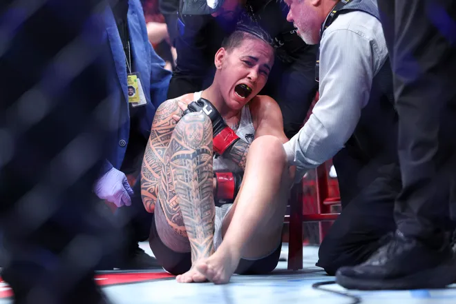 Feb 21, 2026; Houston, Texas, USA; Nora Cornolle (red gloves) fights Joselyne Edwards (blue gloves) in a womens bantamweight bout during UFC Fight Night at Toyota Center. Mandatory Credit: Troy Taormina-Imagn Images