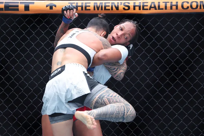 Feb 21, 2026; Houston, Texas, USA; Nora Cornolle (red gloves) fights Joselyne Edwards (blue gloves) in a womens bantamweight bout during UFC Fight Night at Toyota Center. Mandatory Credit: Troy Taormina-Imagn Images