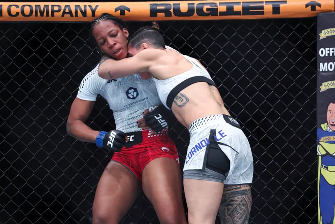 Feb 21, 2026; Houston, Texas, USA; Nora Cornolle (red gloves) fights Joselyne Edwards (blue gloves) in a womens bantamweight bout during UFC Fight Night at Toyota Center. Mandatory Credit: Troy Taormina-Imagn Images