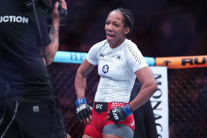 Feb 21, 2026; Houston, Texas, USA; Nora Cornolle (red gloves) fights Joselyne Edwards (blue gloves) in a womens bantamweight bout during UFC Fight Night at Toyota Center. Mandatory Credit: Troy Taormina-Imagn Images