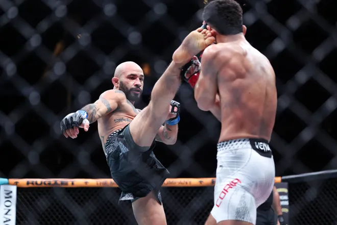 Feb 21, 2026; Houston, Texas, USA; Alden Coria (red gloves) fights Luis Gurule (blue gloves) in a flyweight bout during UFC Fight Night at Toyota Center. Mandatory Credit: Troy Taormina-Imagn Images