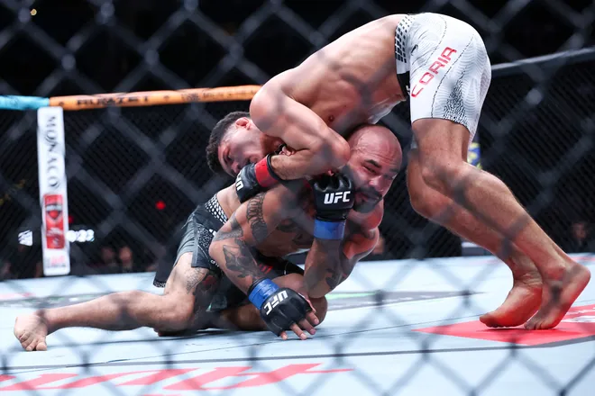 Feb 21, 2026; Houston, Texas, USA; Alden Coria (red gloves) fights Luis Gurule (blue gloves) in a flyweight bout during UFC Fight Night at Toyota Center. Mandatory Credit: Troy Taormina-Imagn Images