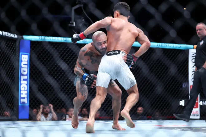 Feb 21, 2026; Houston, Texas, USA; Alden Coria (red gloves) fights Luis Gurule (blue gloves) in a flyweight bout during UFC Fight Night at Toyota Center. Mandatory Credit: Troy Taormina-Imagn Images