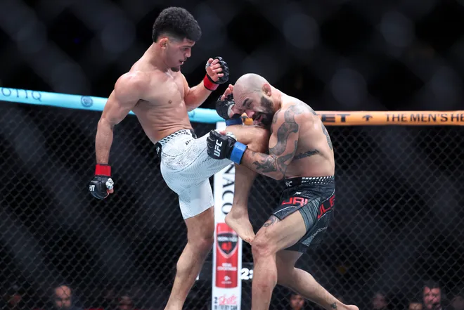 Feb 21, 2026; Houston, Texas, USA; Alden Coria (red gloves) fights Luis Gurule (blue gloves) in a flyweight bout during UFC Fight Night at Toyota Center. Mandatory Credit: Troy Taormina-Imagn Images