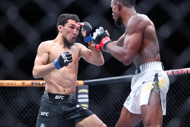 Feb 21, 2026; Houston, Texas, USA; Ode Osbourne (red gloves) fights Alibi Idiris (blue gloves) in a flyweight bout during UFC Fight Night at Toyota Center. Mandatory Credit: Troy Taormina-Imagn Images