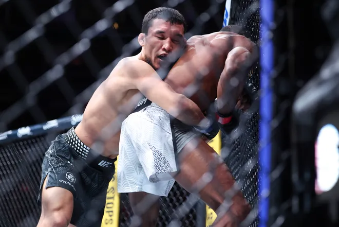 Feb 21, 2026; Houston, Texas, USA; Ode Osbourne (red gloves) fights Alibi Idiris (blue gloves) in a flyweight bout during UFC Fight Night at Toyota Center. Mandatory Credit: Troy Taormina-Imagn Images