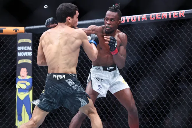 Feb 21, 2026; Houston, Texas, USA; Ode Osbourne (red gloves) fights Alibi Idiris (blue gloves) in a flyweight bout during UFC Fight Night at Toyota Center. Mandatory Credit: Troy Taormina-Imagn Images