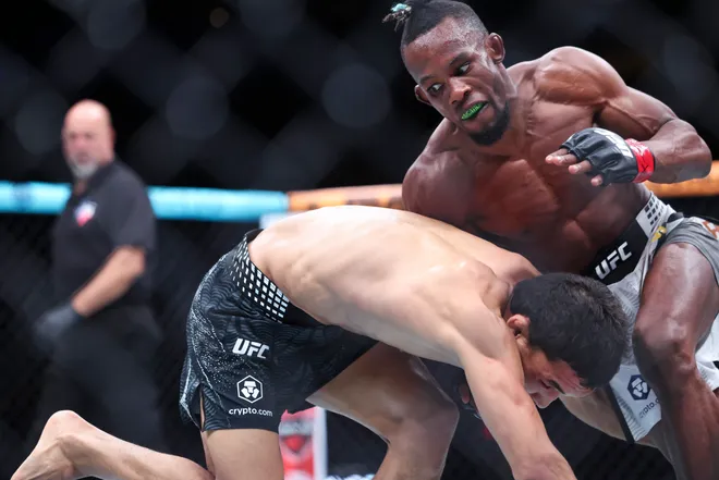 Feb 21, 2026; Houston, Texas, USA; Ode Osbourne (red gloves) fights Alibi Idiris (blue gloves) in a flyweight bout during UFC Fight Night at Toyota Center. Mandatory Credit: Troy Taormina-Imagn Images