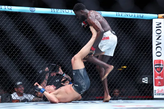 Feb 21, 2026; Houston, Texas, USA; Chidi Njokuani (red gloves) fights Carlos Leal (blue gloves) in a welterweight bout during UFC Fight Night at Toyota Center. Mandatory Credit: Troy Taormina-Imagn Images