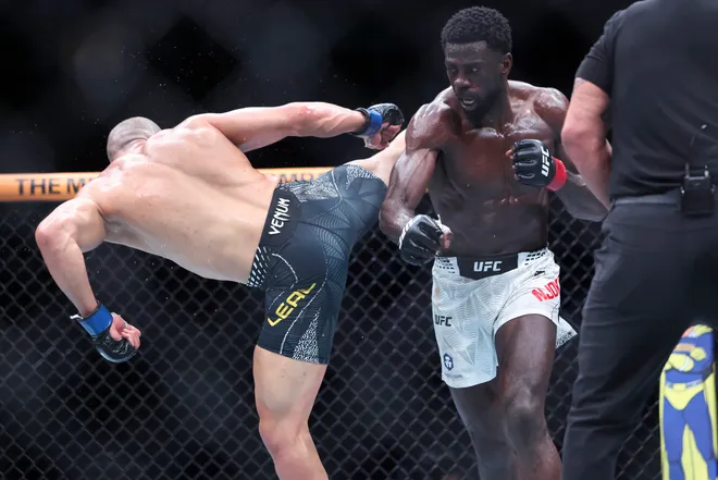 Feb 21, 2026; Houston, Texas, USA; Chidi Njokuani (red gloves) fights Carlos Leal (blue gloves) in a welterweight bout during UFC Fight Night at Toyota Center. Mandatory Credit: Troy Taormina-Imagn Images