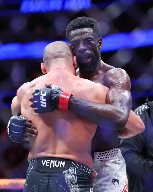 Feb 21, 2026; Houston, Texas, USA; Chidi Njokuani (red gloves) fights Carlos Leal (blue gloves) in a welterweight bout during UFC Fight Night at Toyota Center. Mandatory Credit: Troy Taormina-Imagn Images