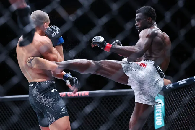 Feb 21, 2026; Houston, Texas, USA; Chidi Njokuani (red gloves) fights Carlos Leal (blue gloves) in a welterweight bout during UFC Fight Night at Toyota Center. Mandatory Credit: Troy Taormina-Imagn Images
