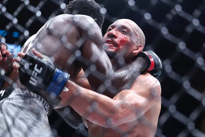 Feb 21, 2026; Houston, Texas, USA; Chidi Njokuani (red gloves) fights Carlos Leal (blue gloves) in a welterweight bout during UFC Fight Night at Toyota Center. Mandatory Credit: Troy Taormina-Imagn Images