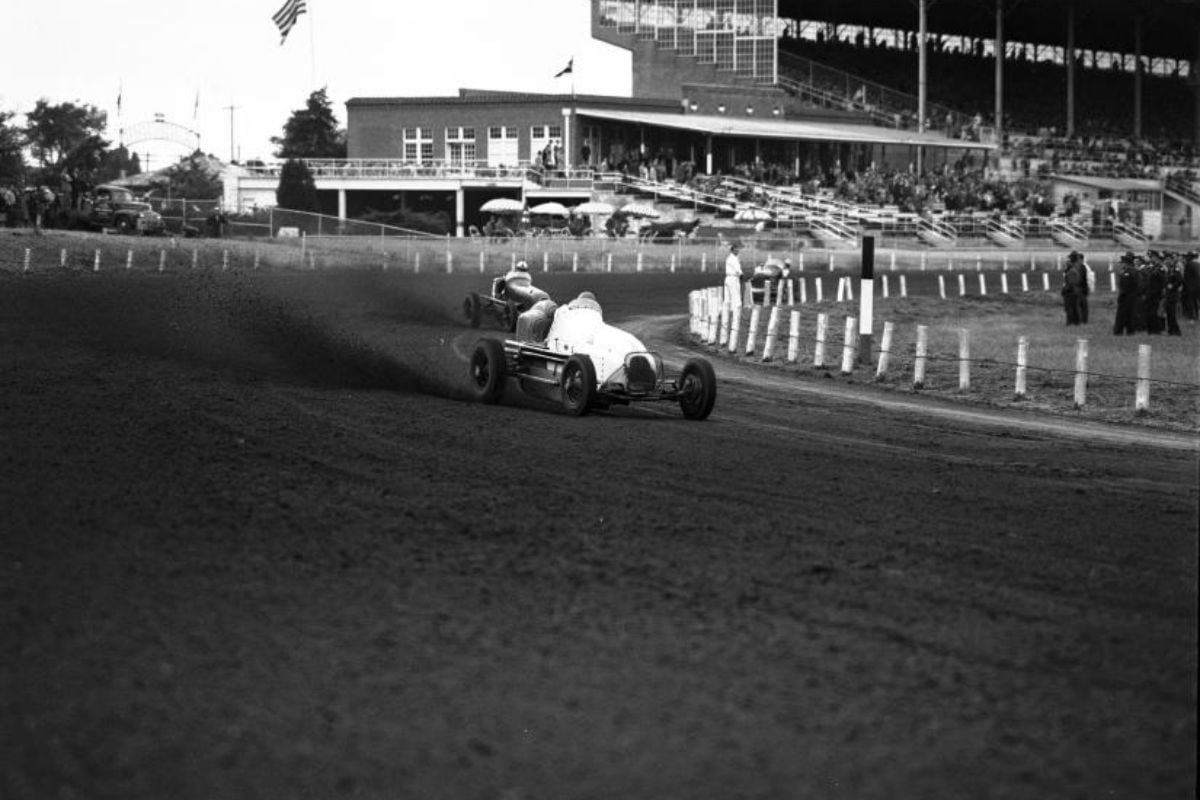 Driver Ted Horn as he skidding around the first turn in race at Arlington Downs with Duke Nalon following closely behind" style=" height:800px; width:1200px" _languageinserted="true" src="https://cdn.prod.web.uta.edu/-/media/96bae364fcd142c9b8749969d18eee0c.jpg