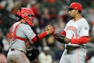 Cincinnati Reds relief pitcher Alexis Diaz (43) and catcher Jose Trevino, left, celebrate...