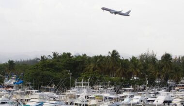 An American Airlines jet lifts off near a marina in San Juan, Puerto Rico, Friday, June 13, 2008. (AP Photo/Brennan Linsley)