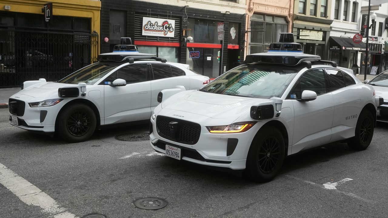 Waymo vehicles wait at an intersection in San Francisco, Wednesday, Oct. 22, 2025. (AP Photo/Jeff Chiu)