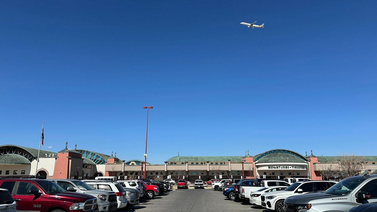 A plane flies over El Paso International Airport, Wednesday, Feb. 11, 2026, in El Paso, Texas. (AP Photo/Morgan Lee)
