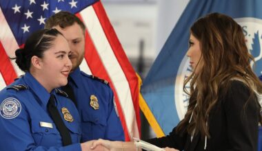 U.S. Homeland Security Secretary Kristi Noem, right, shakes hands with Transportation Security Administration Officer Monica Degro at a news conference at Harry Reid International Airport, Nov. 22, 2025, in Las Vegas. (AP Photo/Ronda Churchill, File)