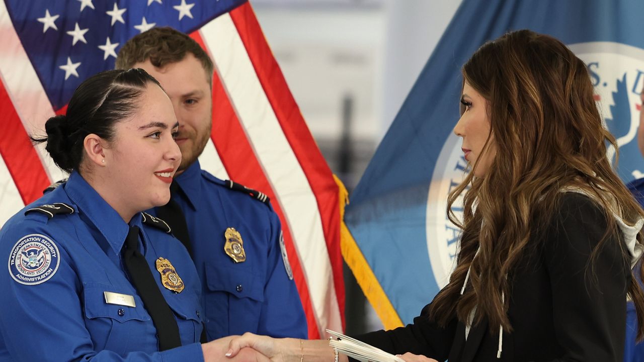 U.S. Homeland Security Secretary Kristi Noem, right, shakes hands with Transportation Security Administration Officer Monica Degro at a news conference at Harry Reid International Airport, Nov. 22, 2025, in Las Vegas. (AP Photo/Ronda Churchill, File)