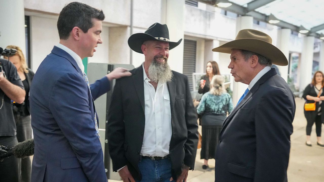 Forrest Welborn, middle, arrives with his attorneys at the exoneration hearing for four men wrongfully accused in the 1991 Austin yogurt shop murders at the Blackwell-Thurman Criminal Justice Center in Austin on Thursday, Feb. 19, 2026. (Jay Janner/Austin American-Statesman via AP)