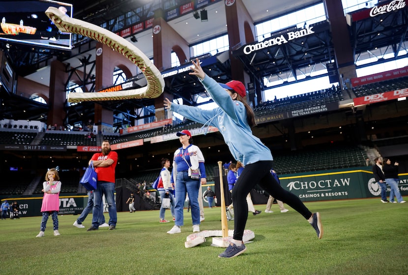 Caitlin Howard, 16, of Dallas tosses foam-filled horseshoe toward a mounted baseball bat in...