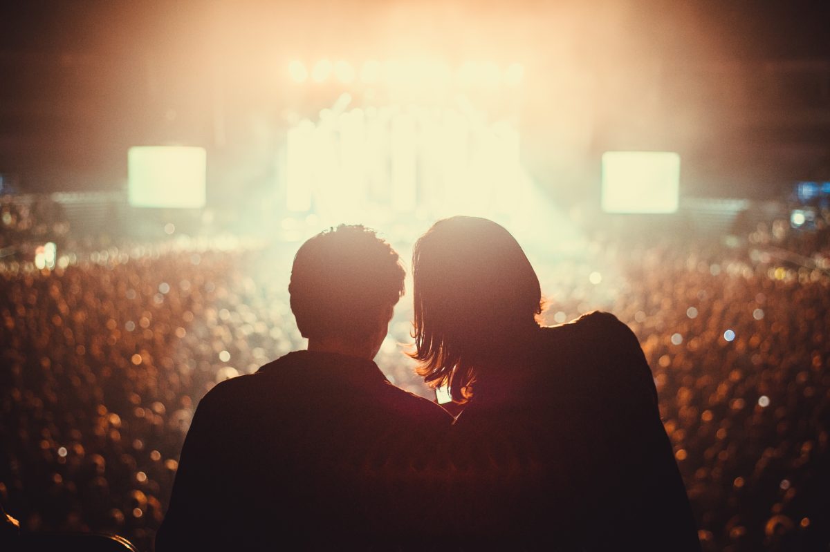 Silhouette of two people at a rock concert