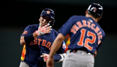 Houston Astros' Isaac Paredes, left, rounds the bases past third base coach Tony Perezchica (12) after hitting a three-run home run off Texas Rangers relief pitcher Robert Garcia during the eighth inning of a baseball game in Arlington, Texas, Sunday, May 18, 2025. (AP Photo/Jerome Miron)
