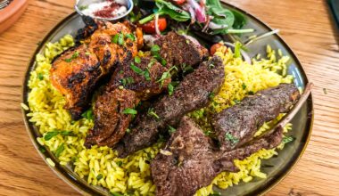 A bowl of rice topped with lamb and beef skewers from Ayat.