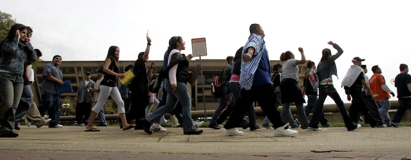 On March 27, 2006, Dallas ISD students marched down a sidewalk along Young St. to a rally at...