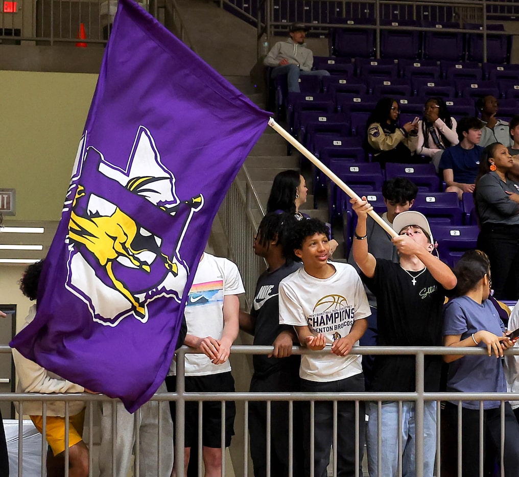 A Denton student waves their flag during the game against Mansfield Timberview in a 5A...