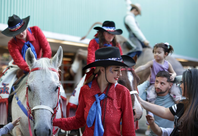 Rodeo riders and their horses greet fairgoers at the State Fair of Texas in 2024. The rodeo...