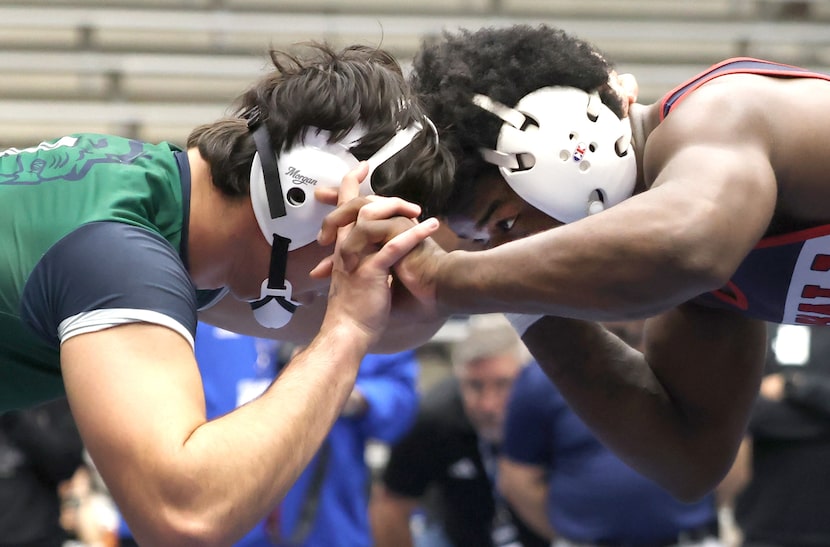 Dallas Kimball wrestler Quintraylon Johnson, right, plans his strategy against Frisco Reedy...