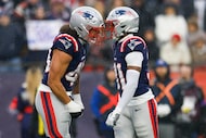 New England Patriots linebacker Jahlani Tavai (48) celebrates with safety Craig Woodson (31)...