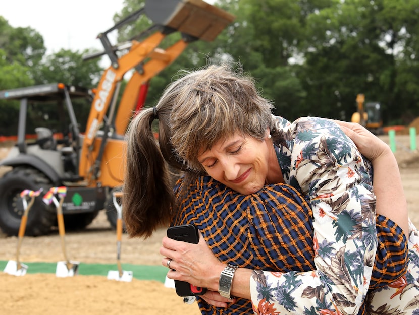 Dianna Grey, left, and Cece Cox hug as community members celebrate a groundbreaking for Oak...