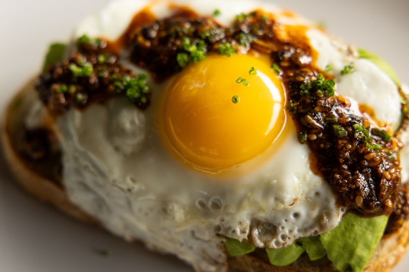 Avocado toast at AM/FM in Dallas is topped with salsa macha, a Mexican chili oil.