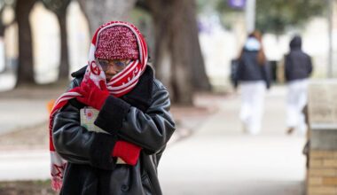 Graduate student Jaylynn West walks to class bundled up in a scarf and beanie on campus at TCU in Fort Worth on Wednesday, Feb. 19, 2025.