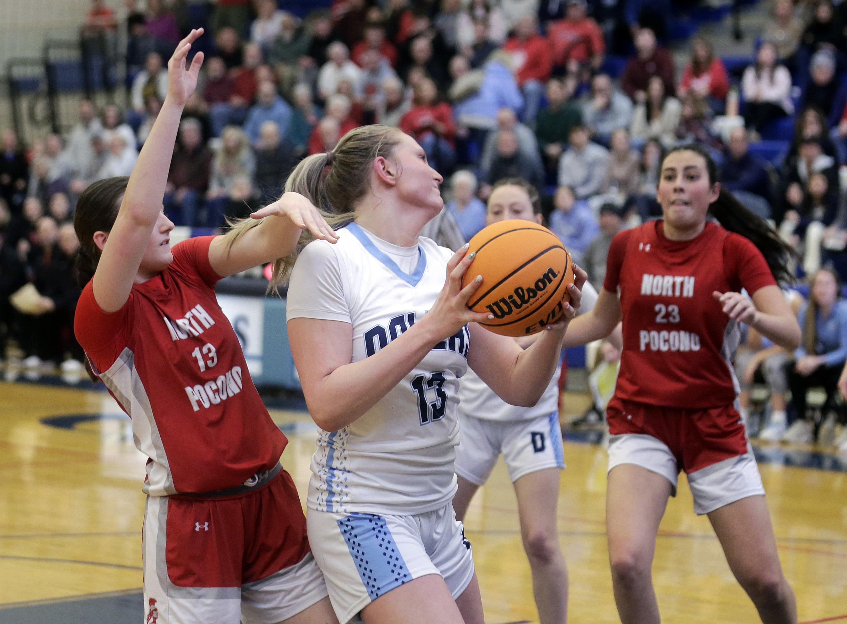 Dallas’ Odessa Kanton, center, grabs an offensive rebound ahead of...