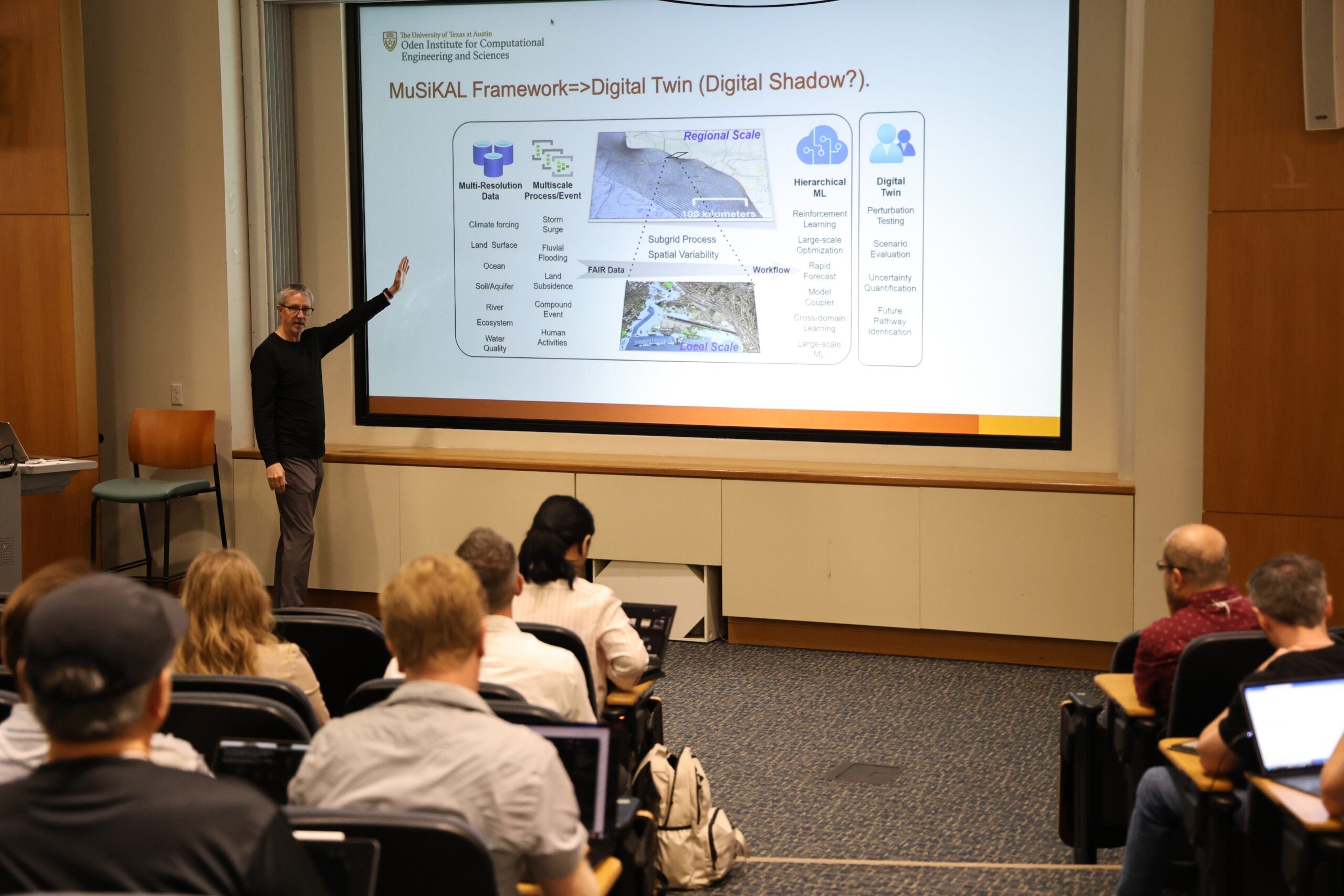 man points to powerpoint slide on projected screen