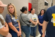 Parents of Wolford Elementary students commiserate in the hallway after a special meeting...